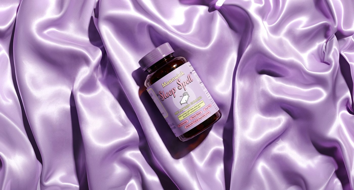 Moonwink Sleep Spell bottle resting on purple silk